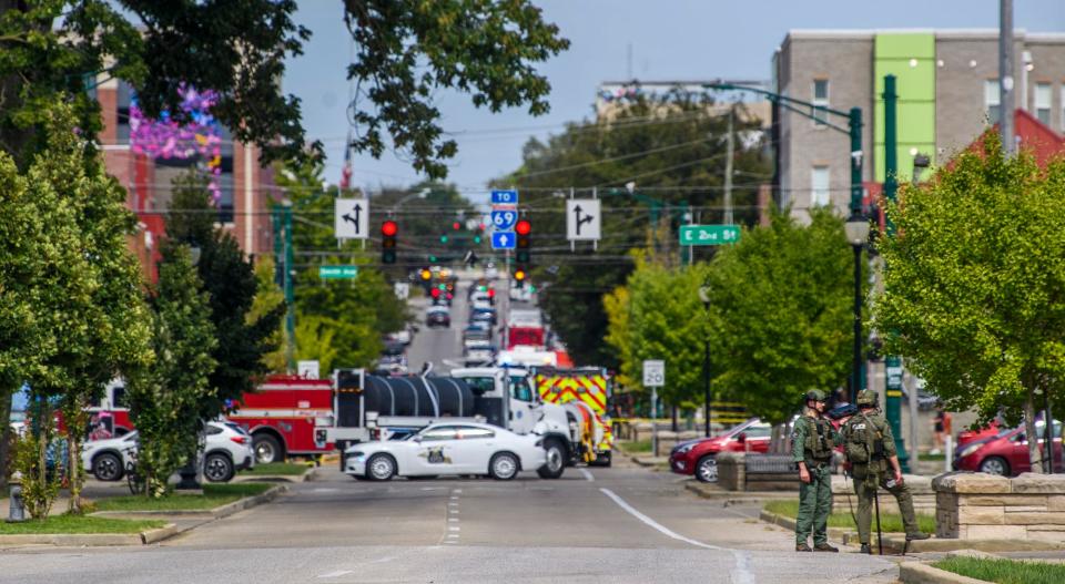 Law enforcement officials search the sewers between First and Second streets on Tuesday, Sept. 20. 2022. They were searching for a person who was barricaded in the sewer system.