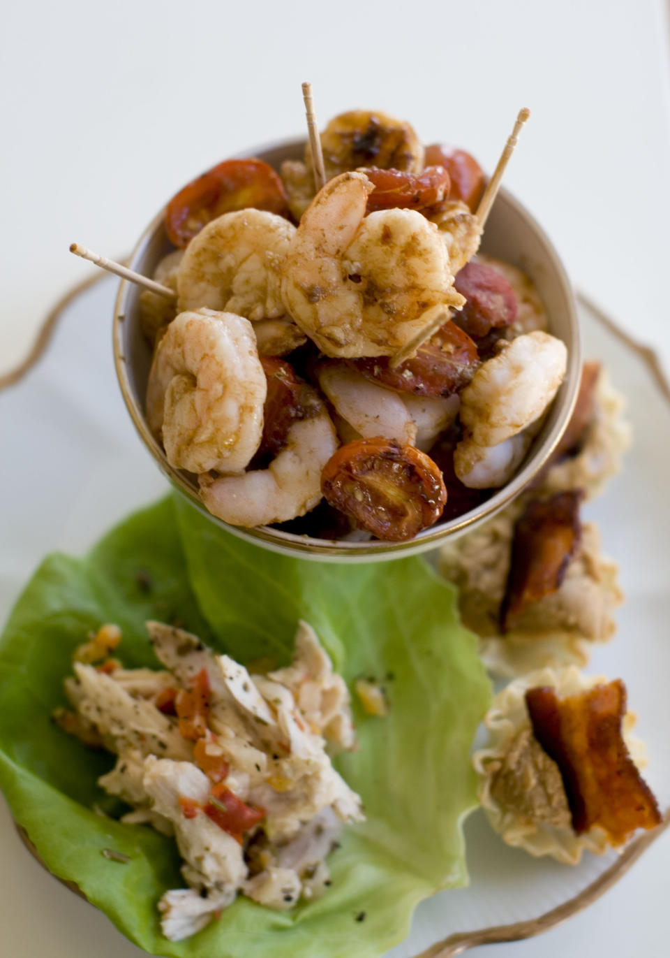 This Nov. 18, 2013 photo shows roasted shrimp cocktail, pinapple chicken lettuce wraps, and Elvis phyllo cups in Concord, N.H. (AP Photo/Matthew Mead)