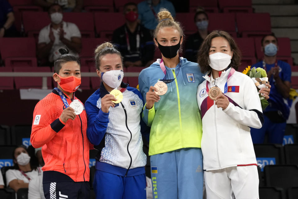From left, silver medalist Funa Tonaki of Japan, gold medalist Distria Krasniqi of Kosovo, and bronze medalists Daria Bilodid of Ukraine and Urantsetseg Munkhbat of Mongolia pose with their medals for women's -48kg judo at the 2020 Summer Olympics, Saturday, July 24, 2021, in Tokyo, Japan. (AP Photo/Vincent Thian)