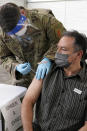 Armelio Acosta receives the Johnson & Johnson COVID-19 vaccine at a FEMA mass vaccination center at Miami Dade College, Wednesday, March 3, 2021, in North Miami, Fla. This is one of four FEMA sites in Florida that opened Wednesday with capacity to vaccinate up to 3,000 people a day seven days a week. (AP Photo/Marta Lavandier)