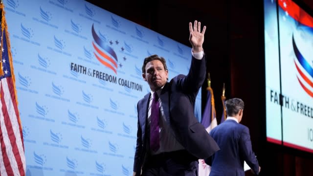 Florida Gov. Ron DeSantis waves to the crowd at the Iowa Faith & Freedom Coalition town hall