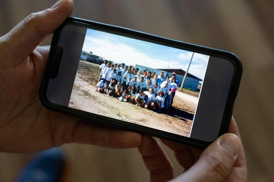 Joel French displays a photo on his cellphone of alleged molester Bradley Earl Reger in a group picture with students from the Cornerstone Christian School during a mission trip to Mexico.