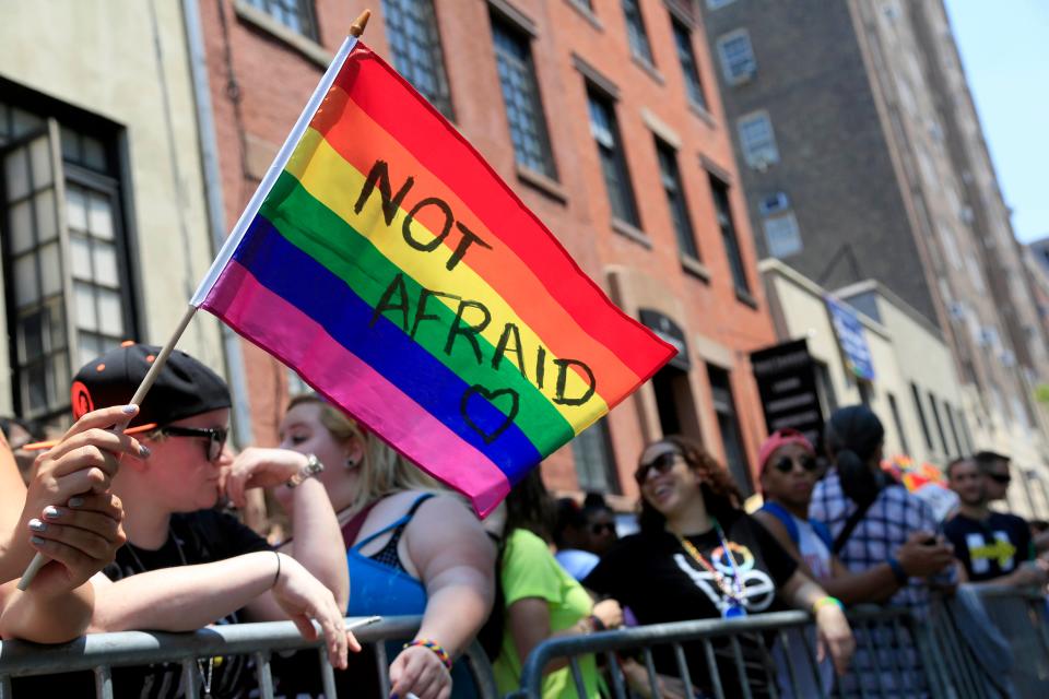 An individual  holds a rainbow flag during the NYC Pride Parade in New York on June 26, 2016.