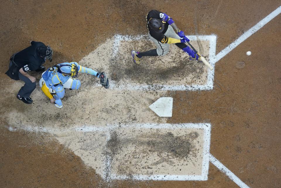 San Diego Padres' Manny Machado hits a home run during the fourth inning of a baseball game against the Milwaukee Brewers Friday, Aug. 25, 2023, in Milwaukee. (AP Photo/Morry Gash)