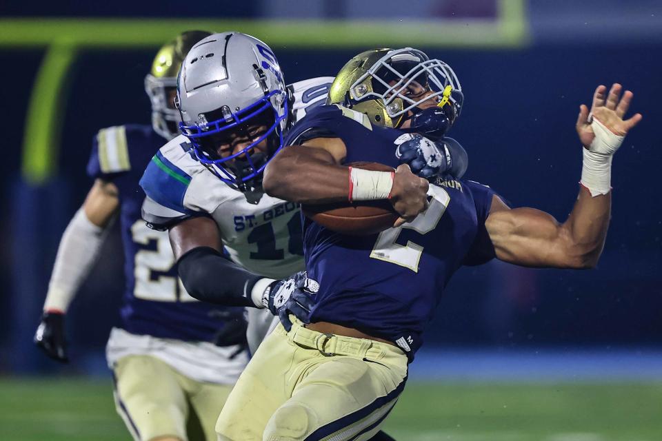 Salesianum running back Brian Alleyne (2) is tackled by St. George’s defensive end Jase Munson (10) during a regular season game between St. George’s and Salesianum Friday, Oct. 06, 2023, at Abessinio Stadium in Wilmington, DE.