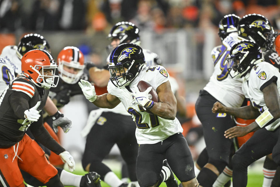 Baltimore Ravens running back J.K. Dobbins, center, carries the ball during the first half of an NFL football game against the Cleveland Browns, Saturday, Dec. 17, 2022, in Cleveland. (AP Photo/David Richard)