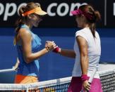 Li Na (R) of China shakes hands with Belinda Bencic of Switzerland after winning their women's singles match at the Australian Open 2014 tennis tournament in Melbourne January 15, 2014. REUTERS/Jason Reed