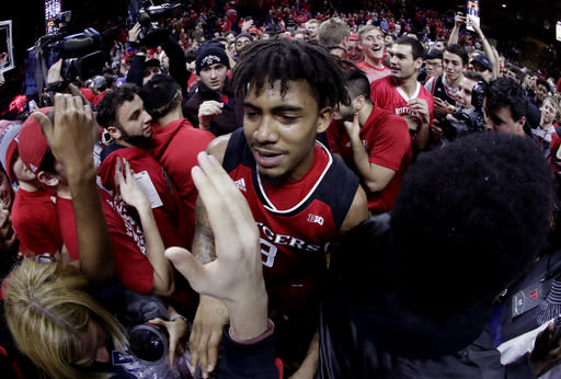Rutgers guard Corey Sanders is mobbed by fans after upsetting Seton Hall 71-65 in Piscataway, N.J. (AP Photo)