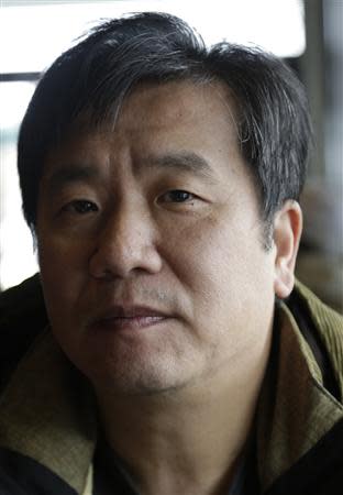 Lian Yang poses for a portrait in a coffee shop near the location where he was secretly recorded by the FBI during an arms trafficking sting operation in the Seattle suburb of Bellevue, Washington December 12, 2013. REUTERS/Jason Redmond