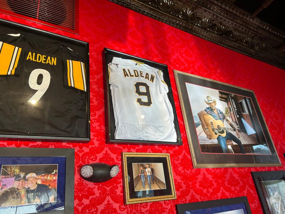 Jason Aldean memorabilia, including his custom Pittsburgh Pirates and Steelers jerseys, adorn the walls of the country star's new Pittsburgh restaurant.