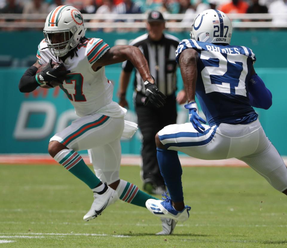 Jaylen Waddle of Miami looks to elude Xavier Rhodes of the Colts at Hard Rock Stadium in Miami Gardens, Fla., on Sunday, Oct. 3, 2021, during first half Miami vs. Indianapolis action. 