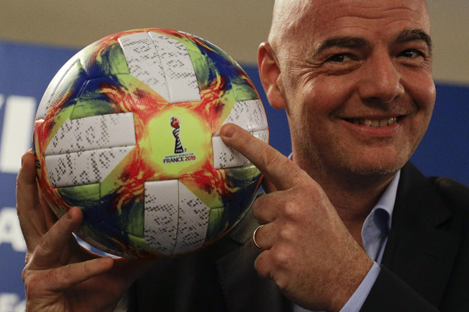 FIFA President Gianni Infantino holds the official ball of the upcoming Women's Soccer World Championship as he poses for photographers during a press conference at the end of an executive committee meeting in Rome, Wednesday, Feb. 27, 2019. (AP Photo/Gregorio Borgia)