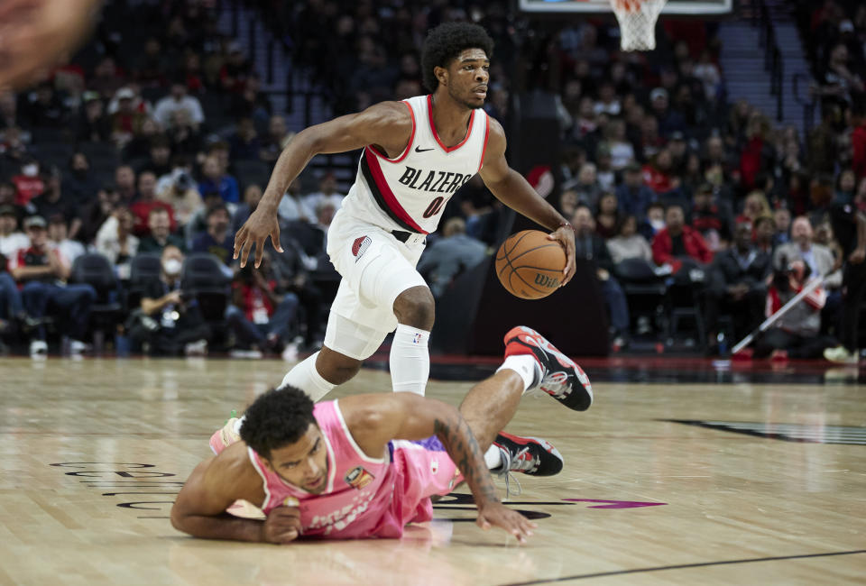 Portland Trail Blazers guard Scoot Henderson dribbles the ball past New Zealand Breakers forward Anthony Lamb during the second half of an NBA preseason basketball game in Portland, Ore., Tuesday, Oct. 10, 2023. (AP Photo/Craig Mitchelldyer)