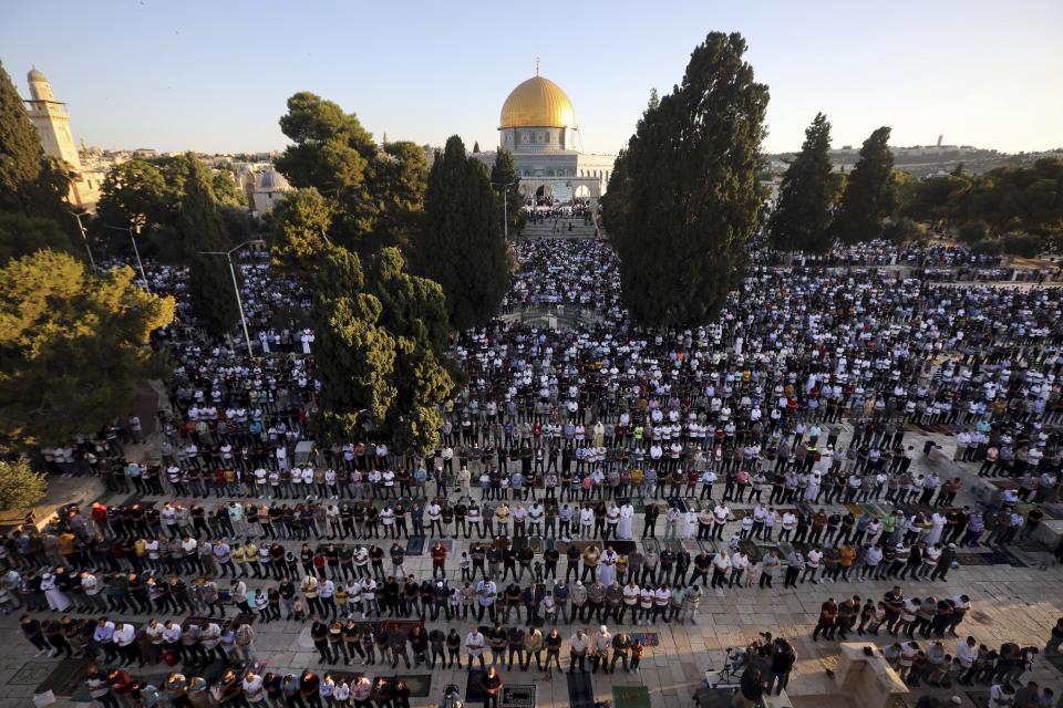 Muslim men offer Eid al-Adha prayer next to the Dome of the Rock Mosque in the Al Aqsa Mosque compound in Jerusalem's old city, Friday, July 31, 2020. This is the first Feast of Sacrifice since the onset of the global coronavirus pandemic. (AP Photo/Mahmoud Illean)