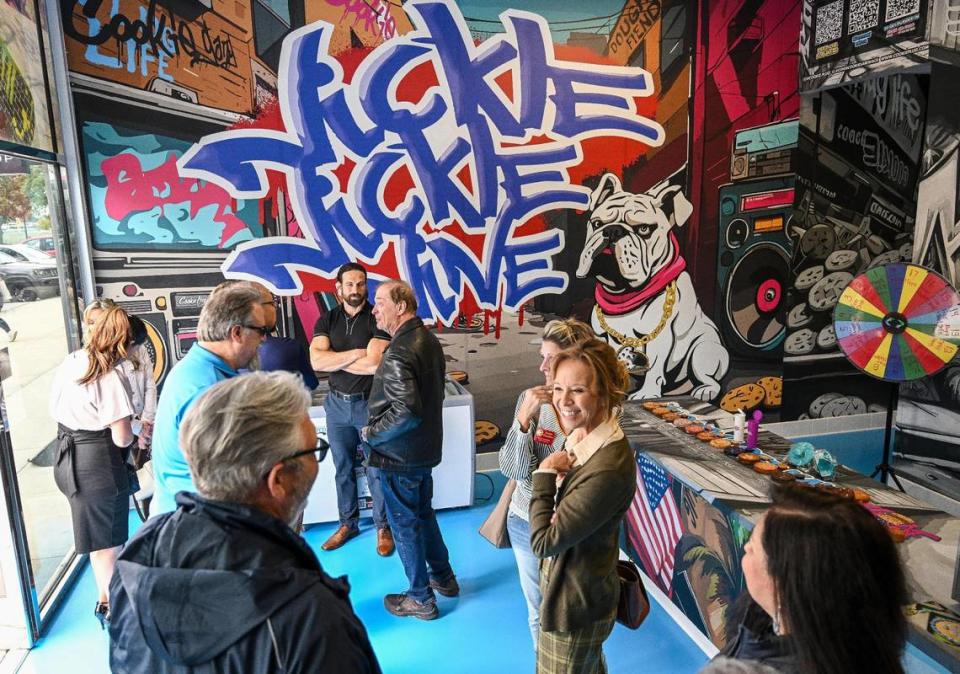 Cookie fans check out Cookie Plug’s new location featuring walls with graffiti and street art during its soft opening and ribbon-cutting event in Fresno State’s Campus Pointe shopping center. Its grand opening is this weekend. CRAIG KOHLRUSS/ckohlruss@fresnobee.com