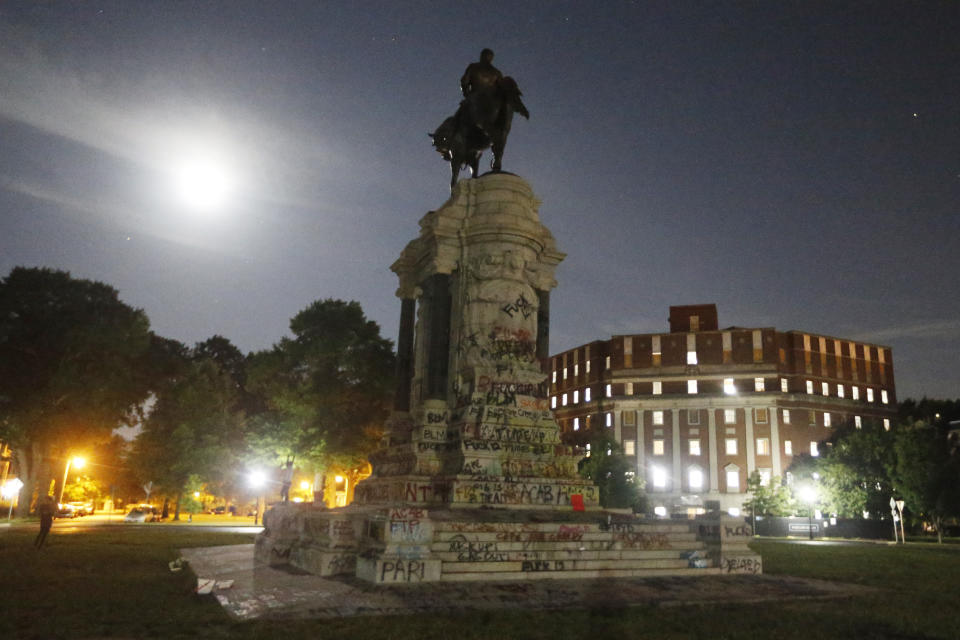 The Moon illuminates the statue of Confederate General Robert E. Lee on Monument Avenue Friday June. 5, 2020, in Richmond, Va. Virginia Gov. Ralph Northam has ordered the removal of the statue. (AP Photo/Steve Helber)