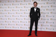 Actor Tom Hiddleston poses for photographers upon arrival at the Bafta Film Awards, in central London, Sunday, April 11 2021. (AP Photo/Alberto Pezzali)