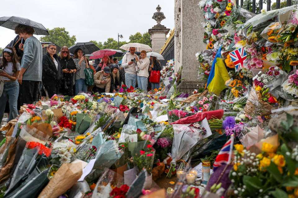 Members of the public visit Buckingham Palace to pay their respects and lay flowers after the death of Queen Elizabeth II on Thursday. Picture date: Friday September 9, 2022.