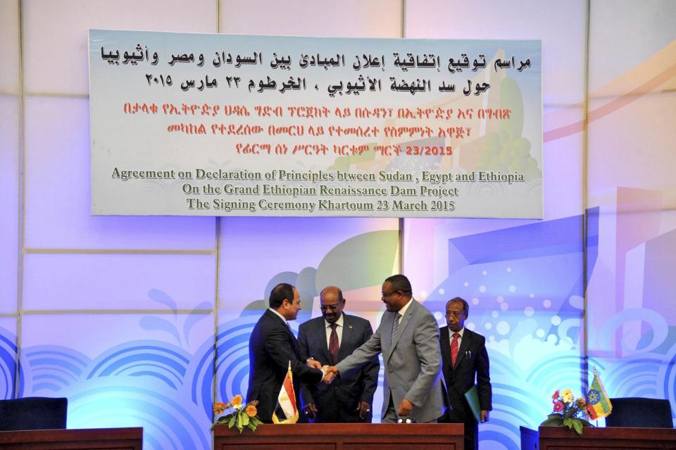File - In this March 23, 2015 file photo, released by the Egyptian Presidency, then Sudanese President Omar al-Bashir, center, Egyptian President Abdel-Fattah el-Sissi, left, and Ethiopian Prime Minister Hailemariam Desalegn, right, hold hands after signing an agreement on sharing water from the Nile River, in Khartoum, Sudan. Speaking at the U.N. summit in Sept. 2019, el-Sissi warned that his country would “never” allow Ethiopia to impose a “de facto situation” where it began filling the dam and limiting Egypt’s share of the river’s flow prior to an agreement. Ethiopia rejected outright Egypt's proposal for international mediation levelled at the U.N. (AP Photo/Ahmed Foad, Egyptian Presidency, File)