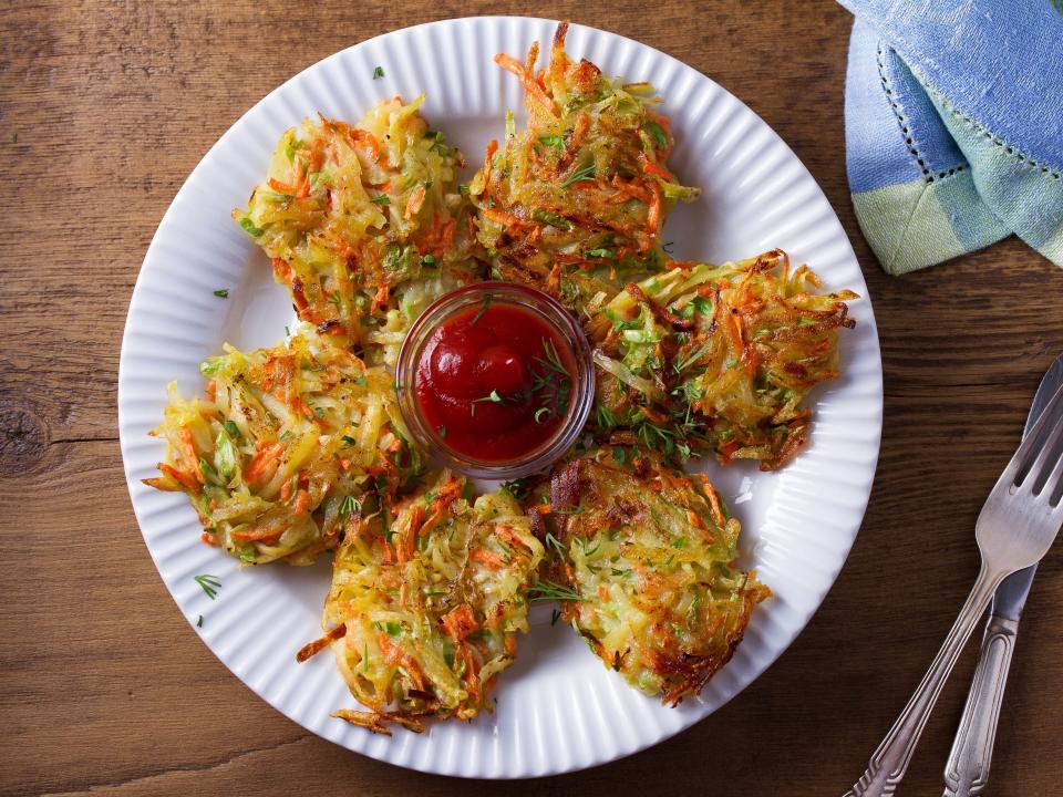 A plate of potato, zucchini, and carrot latkes.