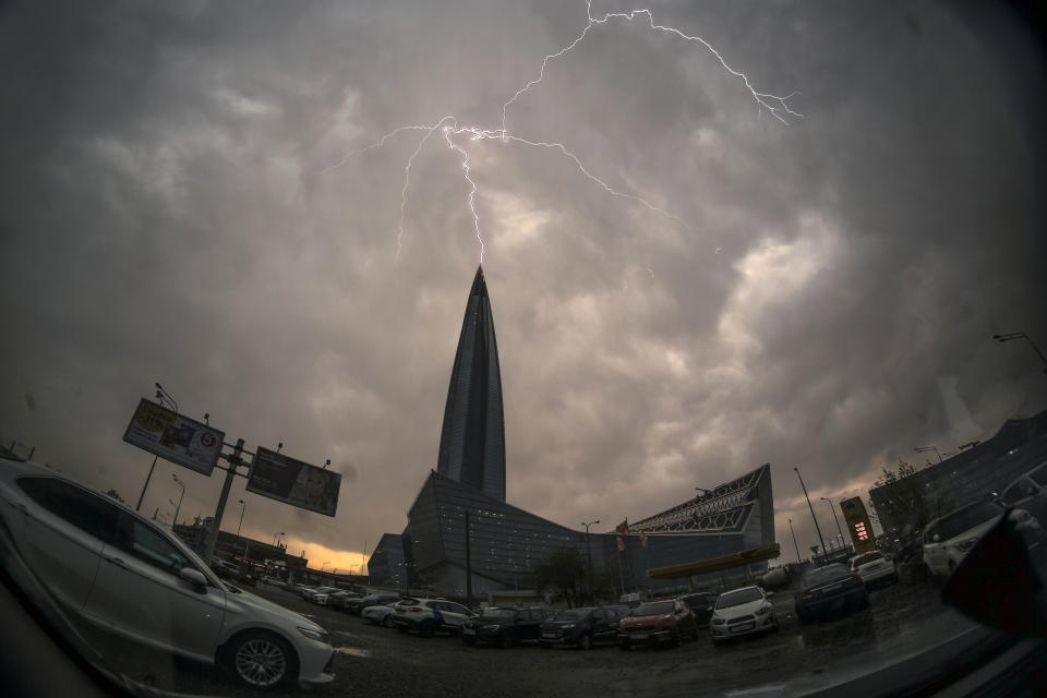 FILE - Lightning strikes the business tower Lakhta Centre, the headquarters of Russian gas monopoly Gazprom in St. Petersburg, Russia, Thursday, May 20, 2021. Russia's Gazprom state-controlled energy giant said it will shut down the Nord Stream 1 natural gas pipeline to Germany for three days of maintenance starting Wednesday, raising economic pressure on Germany and other European countries that depend on the fuel to power industry, generate electricity and heat homes. (AP Photo/Dmitri Lovetsky, File)