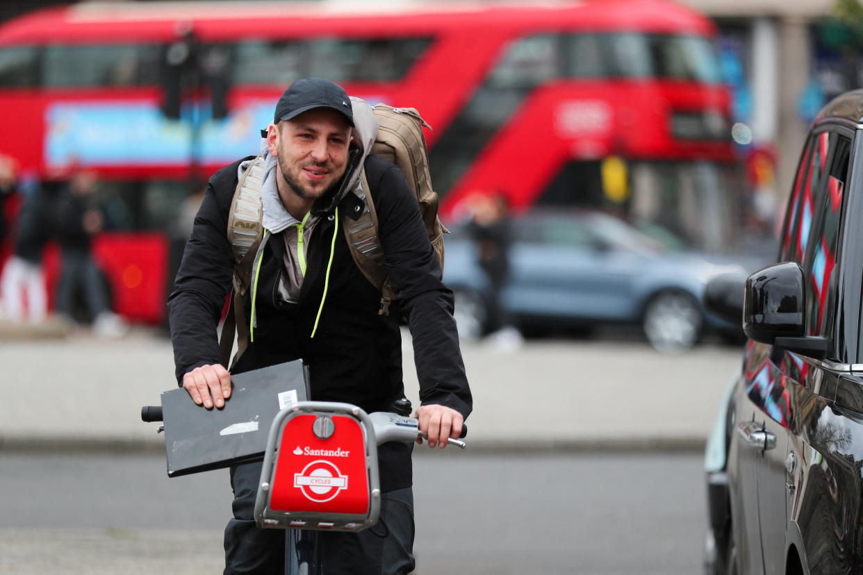 A man rides a bike, as the new Highway Code rules start today together with giving pedestrians priority at junctions, at the junction of Trafalgar Square, in London, Britain, January 29, 2022. REUTERS/May James