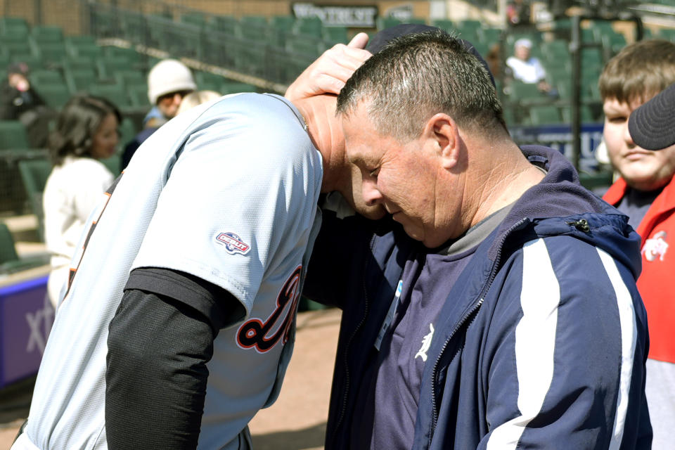 Detroit Tigers' Colt Keith is hugged by his father Troy, before Keith's Major League debut at the Chicago White Sox's home opener baseball game against the Tigers Thursday, March 28, 2024, in Chicago. (AP Photo/Charles Rex Arbogast)