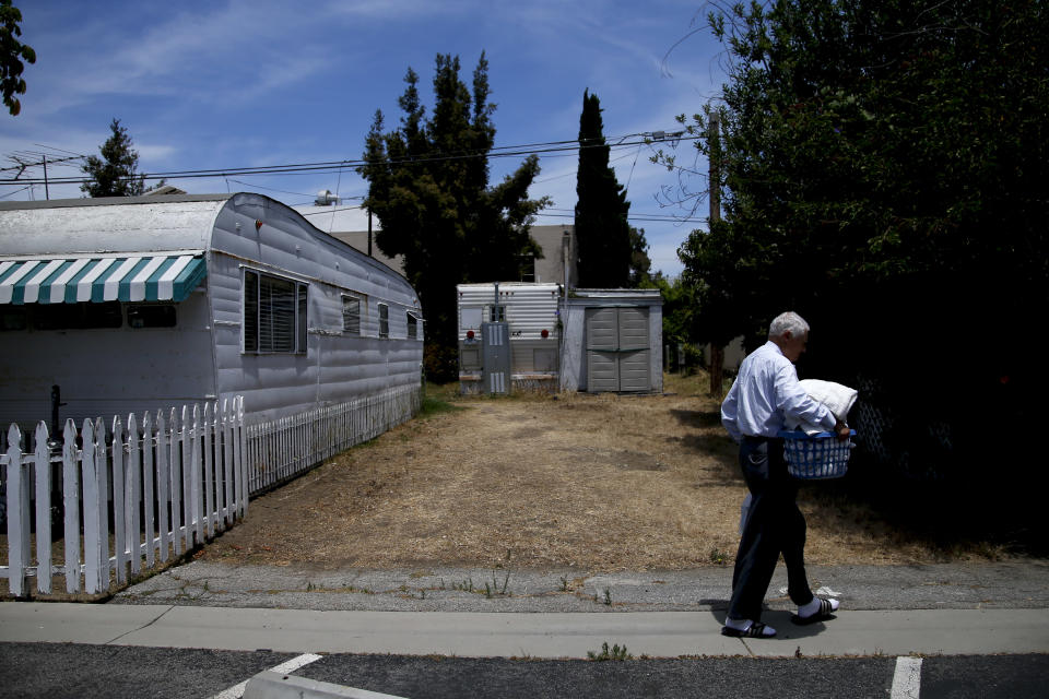 Ralph Meyers, 86, walks to a laundry room at the Santa Monica Village Trailer Park in Santa Monica, Calif., Tuesday, July 10, 2012. The city's Planning Commission recently recommended the 3.8-acre park's zoning be changed to allow a developer to bulldoze its modest, rent-controlled homes and replace them with nearly 200 much-higher-priced apartments and condominiums, as well as more than 100,000 square feet of office and retail space. (AP Photo/Jae C. Hong)