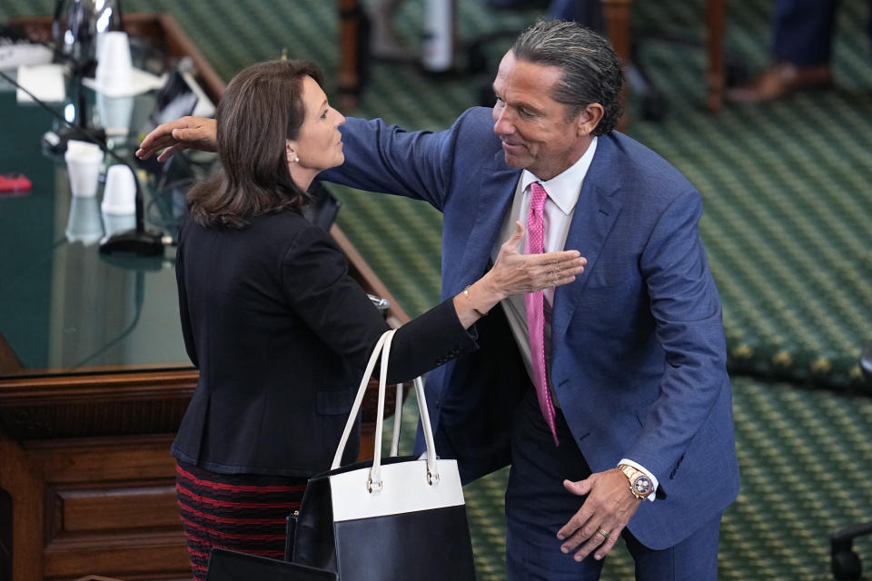 State Sen. Angela Paxton, R-McKinney, wife of suspended Texas state Attorney General Ken Paxton, left, embraces defense attorney Tony Buzbee, right, as they celebrate the acquittal of her husband in his impeachment trial in the Senate Chamber at the Texas Capitol, Saturday, Sept. 16, 2023, in Austin, Texas. (AP Photo/Eric Gay)