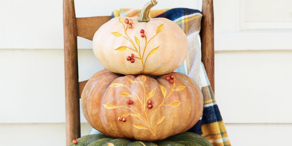 stack of decorated pumpkins with an etched vine detailing