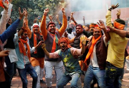 Supporters of Bharatiya Janata Party (BJP) celebrate after learning of the initial poll results at the party headquarters in Lucknow, India March 11, 2017. REUTERS/Pawan Kumar