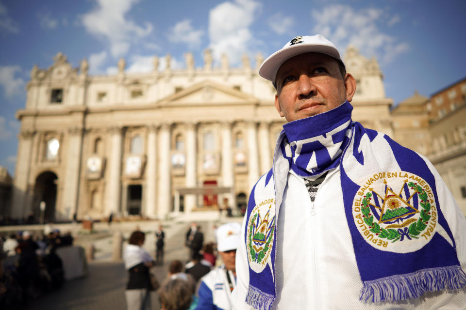 A man wears an El Salvador scarf prior to a canonization ceremony in St. Peter's Square at the Vatican, Sunday, Oct. 14, 2018. Pope Francis canonizes two of the most important and contested figures of the 20th-century Catholic Church, declaring Pope Paul VI and the martyred Salvadoran Archbishop Oscar Romero as models of saintliness for the faithful today. (AP Photo/Andrew Medichini)