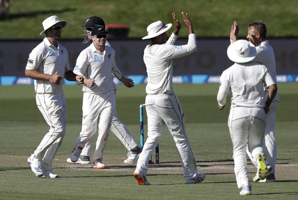 New Zealand's Neil Wagner is congratulated by teammates after taking the wicket of Sri Lanka's Roshen Silva during play on day four of the second cricket test between New Zealand and Sri Lanka at Hagley Oval in Christchurch, New Zealand, Saturday, Dec. 29, 2018. (AP Photo/Mark Baker)
