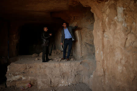 Archaeologist Musab Mohammed Jassim shows artefacts and archaeological pieces in a tunnel network running under the Mosque of Prophet Jonah, Nabi Yunus in Arabic, in eastern Mosul, Iraq March 9, 2017. Picture taken March 9, 2017. REUTERS/Suhaib Salem