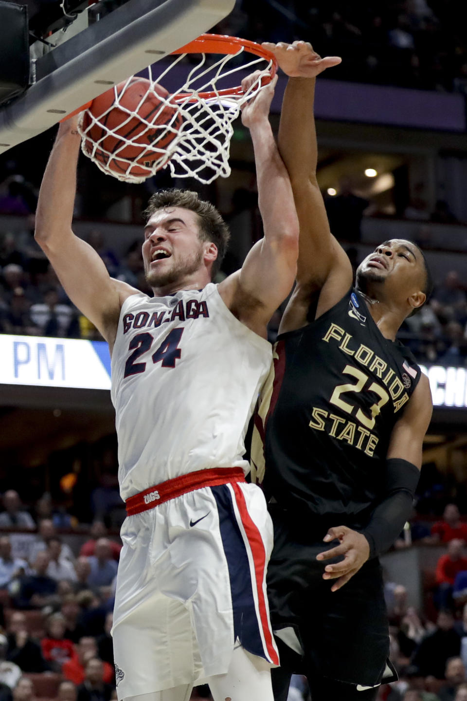 FILE - In this March 28, 2019, file photo, Gonzaga forward Corey Kispert, left, dunks past Florida State guard M.J. Walker during an NCAA men's college basketball tournament West Region semifinal, in Anaheim, Calif. (AP Photo/Marcio Jose Sanchez, File)