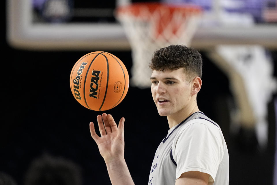 FILE - Connecticut center Donovan Clingan practices for their Final Four college basketball game in the NCAA Tournament on Friday, March 31, 2023, in Houston. While Adama Sanogo, Jordan Hawkins and Andre Jackson are gone, the Huskies return a solid core built around 7-foot-2 sophomore Donovan Clingan and returning starters Alex Karaban and Tristen Newton. (AP Photo/David J. Phillip)