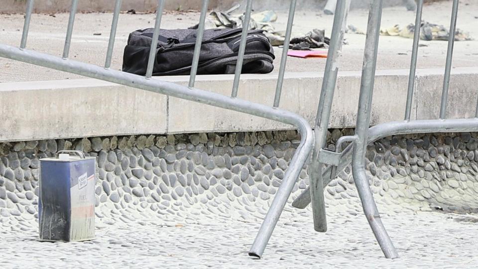 PHOTO: A fuel canister and a backpack are seen, at the scene where a person was covered in flames outside the courthouse where former President Donald Trump's criminal hush money trial is underway, in New York, April 19, 2024.   (Brendan Mcdermid/Reuters)