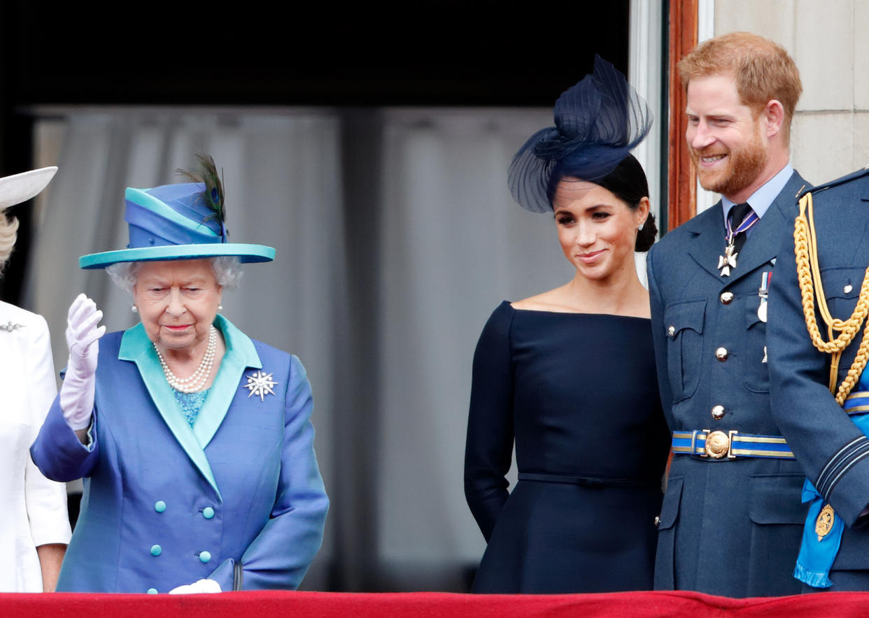 LONDON, UNITED KINGDOM - JULY 10: (EMBARGOED FOR PUBLICATION IN UK NEWSPAPERS UNTIL 24 HOURS AFTER CREATE DATE AND TIME) Queen Elizabeth II, Meghan, Duchess of Sussex and Prince Harry, Duke of Sussex watch a flypast to mark the centenary of the Royal Air Force from the balcony of Buckingham Palace on July 10, 2018 in London, England. The 100th birthday of the RAF, which was founded on on 1 April 1918, was marked with a centenary parade with the presentation of a new Queen's Colour and flypast of 100 aircraft over Buckingham Palace. (Photo by Max Mumby/Indigo/Getty Images)