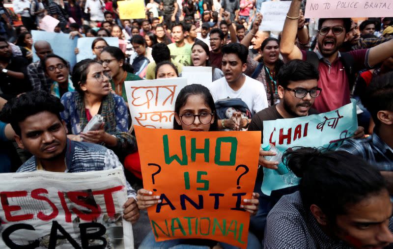 Students hold placards and shout slogans in solidarity with Jamia Millia Islamia university students, in Mumbai