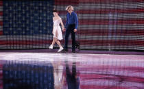 Meryl Davis and Charlie White of the United States step onto the ice before performing in the figure skating exhibition gala at the Iceberg Skating Palace during the 2014 Winter Olympics, Saturday, Feb. 22, 2014, in Sochi, Russia. (AP Photo/Ivan Sekretarev)