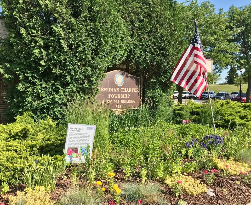 A sign highlighting the importance of pollinators sits outside the Meridian Township Municipal Building on June 21, 2022.