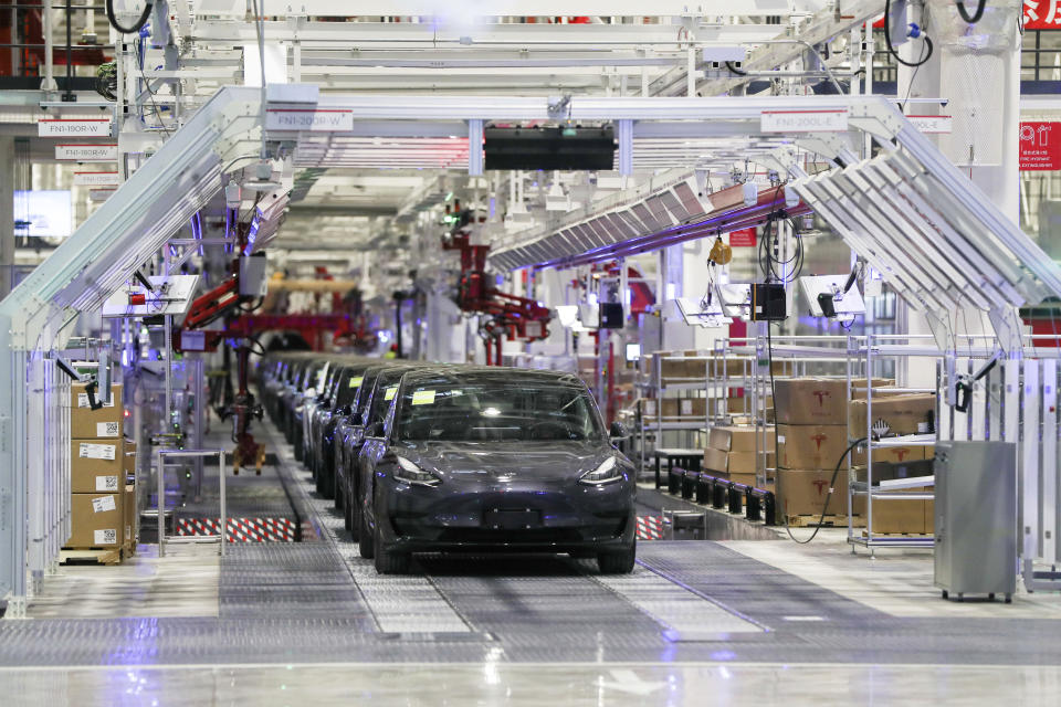 In this photo released by China's Xinhua News Agency, Tesla vehicles are seen on an assembly line at Tesla's gigafactory in Shanghai, Tuesday, Jan. 7, 2020. Tesla's Shanghai factory delivered its first cars to customers Monday, and chief executive Elon Musk said the electric automaker plans to set up a design center in China to create a model for worldwide sales. (Ding Ting/Xinhua via AP)