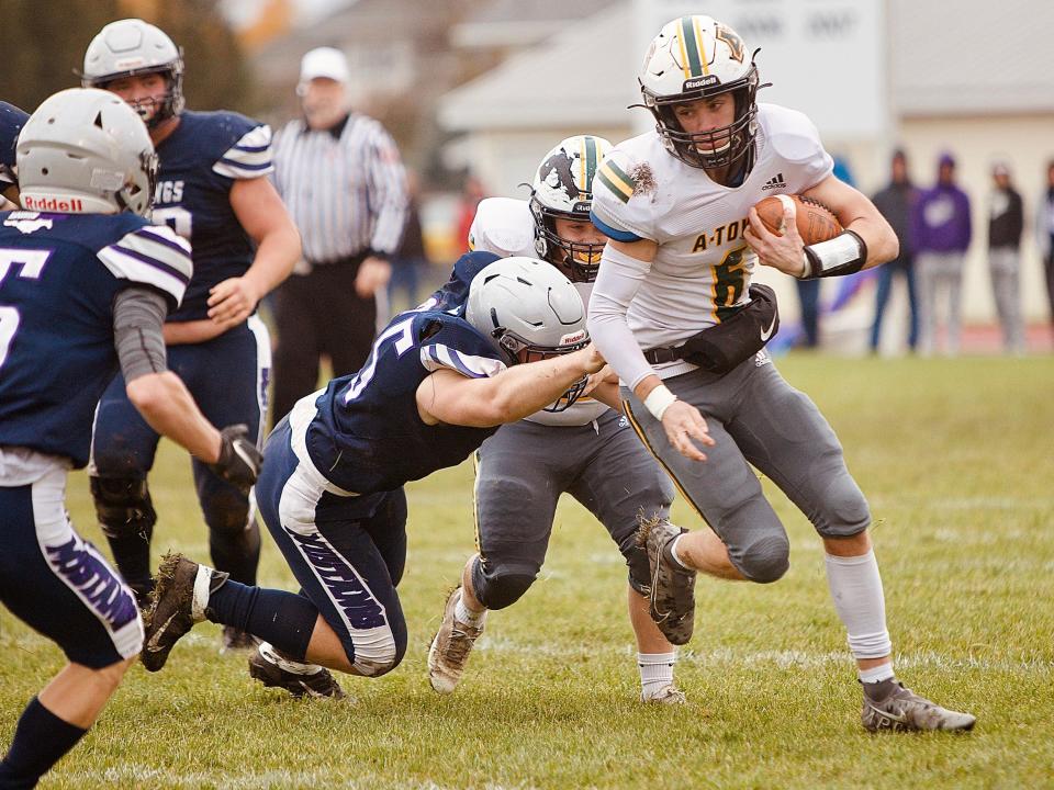 Abingdon-Avon senior Easten Schisler, right, looks for running room on a quarterback keeper during the Tornadoes’ Class 1A quarterfinal matchup with Ridgeview/Lexington on Saturday, Nov. 13, in Colfax.