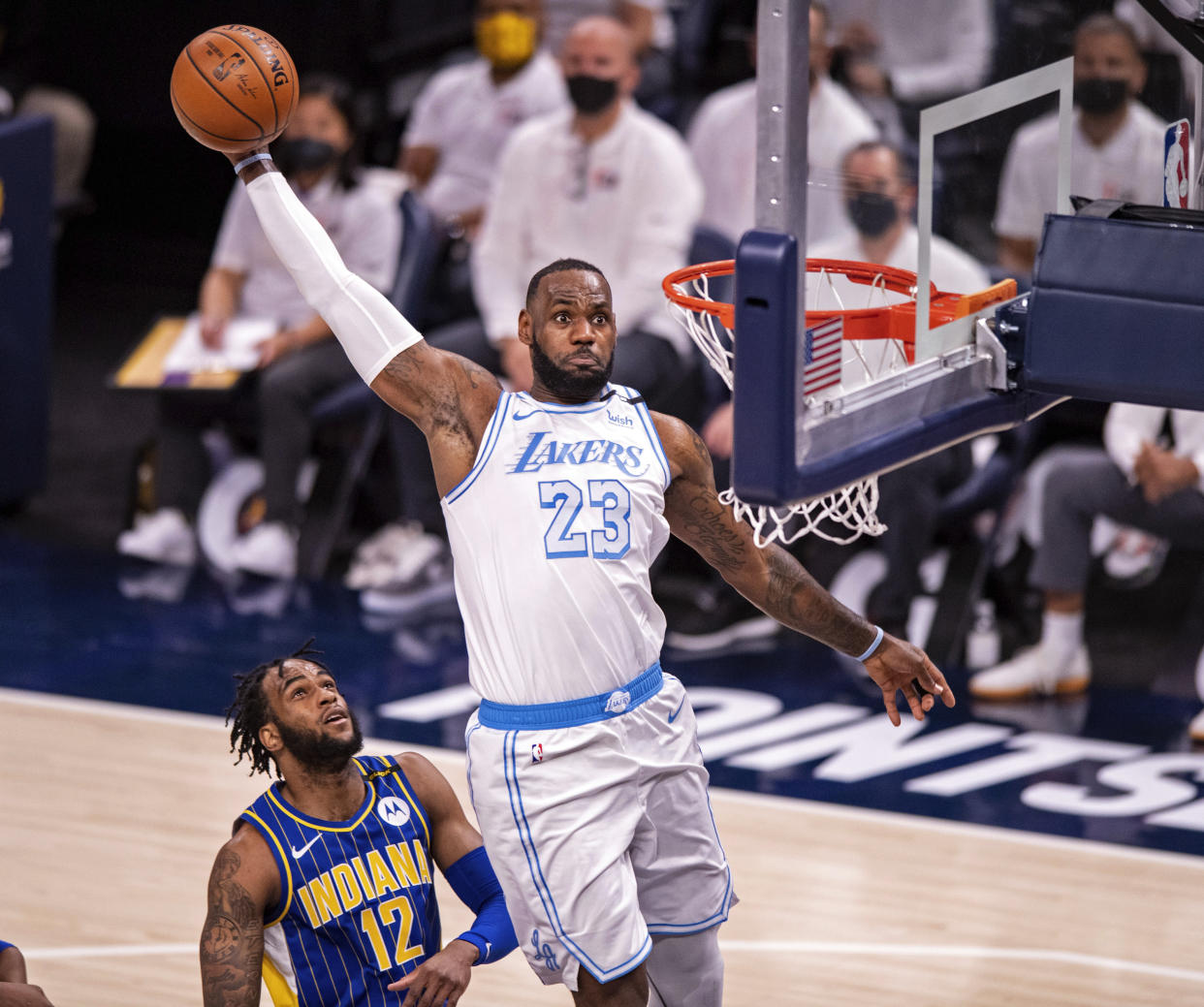 Los Angeles Lakers forward LeBron James (23) slam dunks the ball during the first half of an NBA basketball game against the Indiana Pacers in Indianapolis, Saturday, May 15, 2021. (AP Photo/Doug McSchooler)