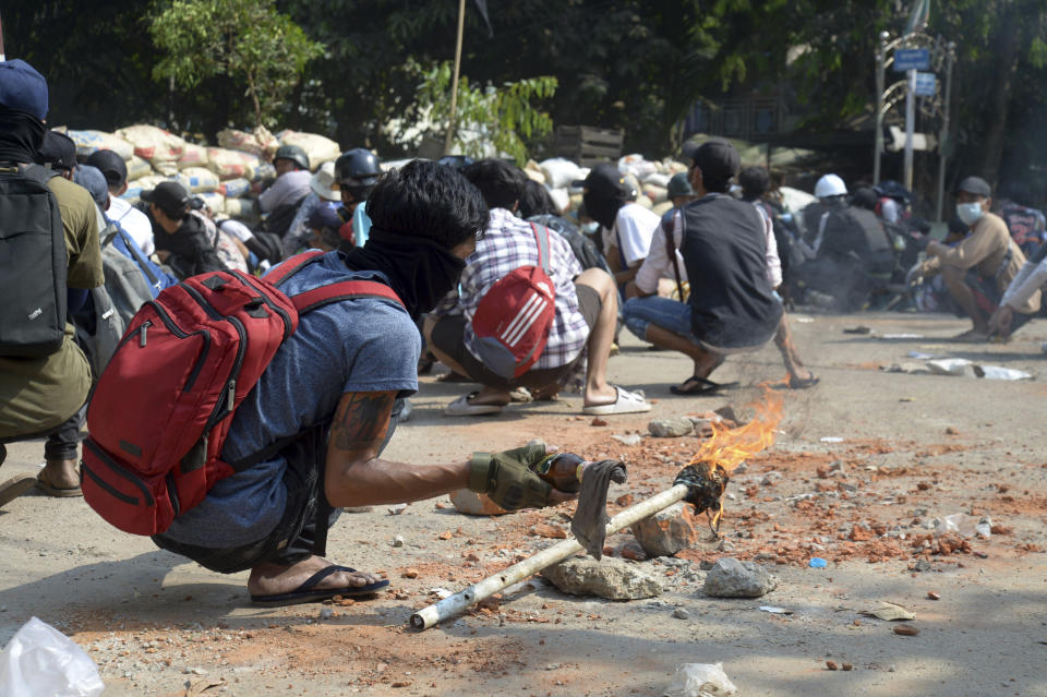 An anti-coup protester prepares a Molotov cocktail in a protest against police crackdown in Yangon, Myanmar Sunday, March 28, 2021. Protesters in Myanmar returned to the streets Sunday to press their demands for a return to democracy, just a day after security forces killed more than 100 people in the bloodiest day since last month's military coup. (AP Photo)