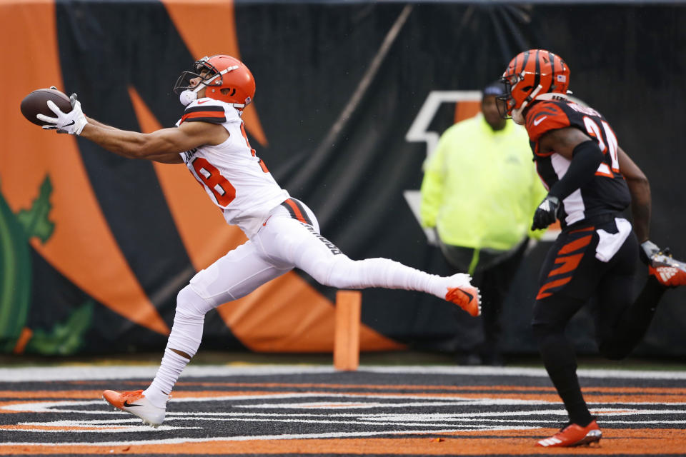 Cleveland Browns wide receiver Damion Ratley catches a 46-yard touchdown pass under pressure from Cincinnati Bengals cornerback Darius Phillips (24) during the first half of an NFL football game, Sunday, Dec. 29, 2019, in Cincinnati. (AP Photo/Gary Landers)