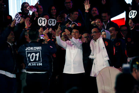 Indonesia's presidential candidate Joko Widodo takes selfie with his supporters during a televised debate with his opponent Prabowo Subianto (not pictured) in Jakarta, Indonesia January 17, 2019. REUTERS/Willy Kurniawan