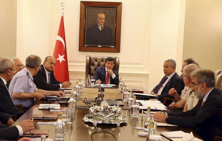 Turkey's Prime Minister Ahmet Davutoglu (C) chairs a security meeting in Ankara, Turkey, in this July 25, 2015 handout provided by Turkey's Prime Minister's Press Office. REUTERS/Hakan Goktepe/Prime Minister's Press Office/Handout via Reuters