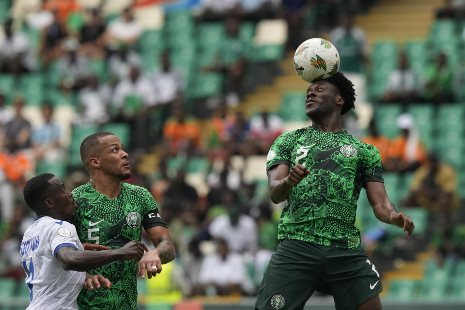 Nigeria's Ola Aina, right, heads the ball during the African Cup of Nations Group A soccer match between Nigeria and Equatorial Guinea's in Abidjan, Ivory Coast, Sunday, Jan. 14, 2024. (AP Photo/Sunday Alamba)