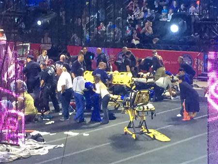 Emergency personnel attend to Ringling Bros. and Barnum & Bailey Circus performers who were injured when the scaffolding they were performing from collapsed in Providence, Rhode Island, May 4, 2014. REUTERS/Aletha Wood